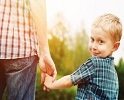 Son holding father's hand