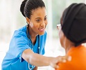 Black Nurse Touching Patient 