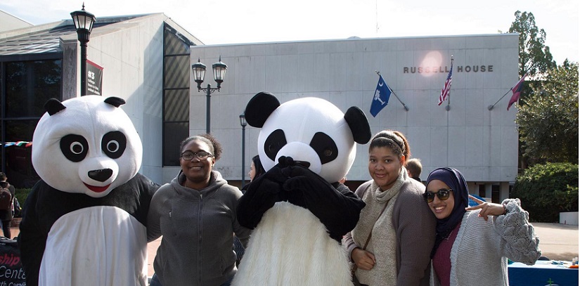 The females pose with the two panda mascots during the Festival event. 