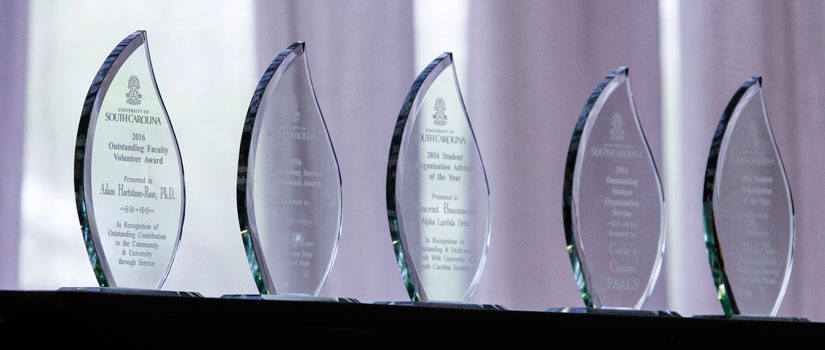 Trophies from previous award ceremonies arranged in a line.