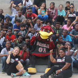 The UofSC Mascot, Cocky, poses with students of all ages.