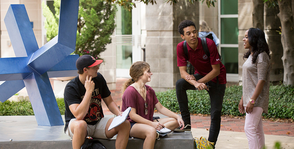 group of students hanging out in front of the Museum of Art