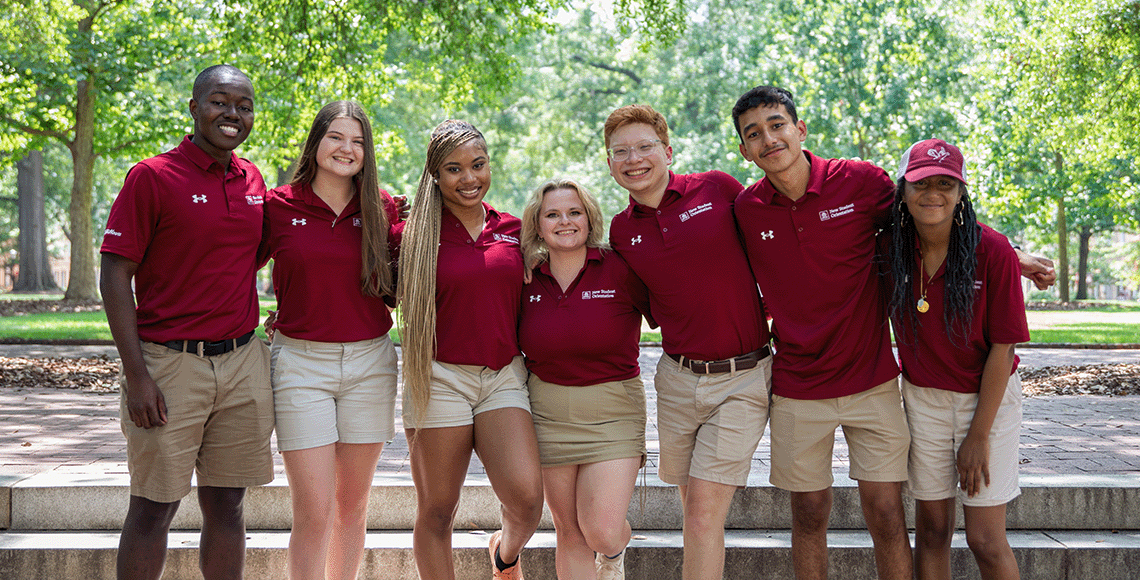 Orientation Leaders smiling outside and posing for a picture outside on the Horseshoe