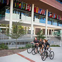 Students on bikes in front of the DMSB
