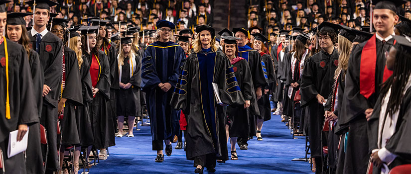Provost Arnett leads the faculty down the middle aisle during the processional at commencement
