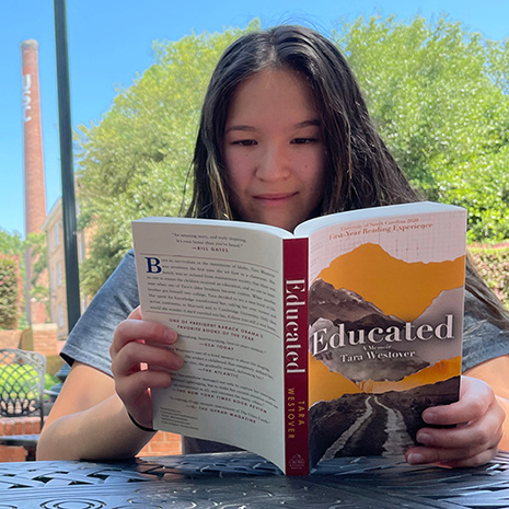 A student reads the book 'Educated.'