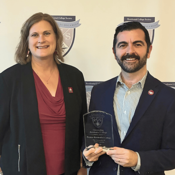Photo of Lara Lomicka Anderson and Armen Shaomian accepting the Outstanding Residential College Award Photo of Lara Lomicka Anderson and Armen Shaomian accepting the Outstanding Residential College Award