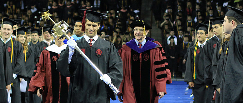 graduate shaking hands with president and dean