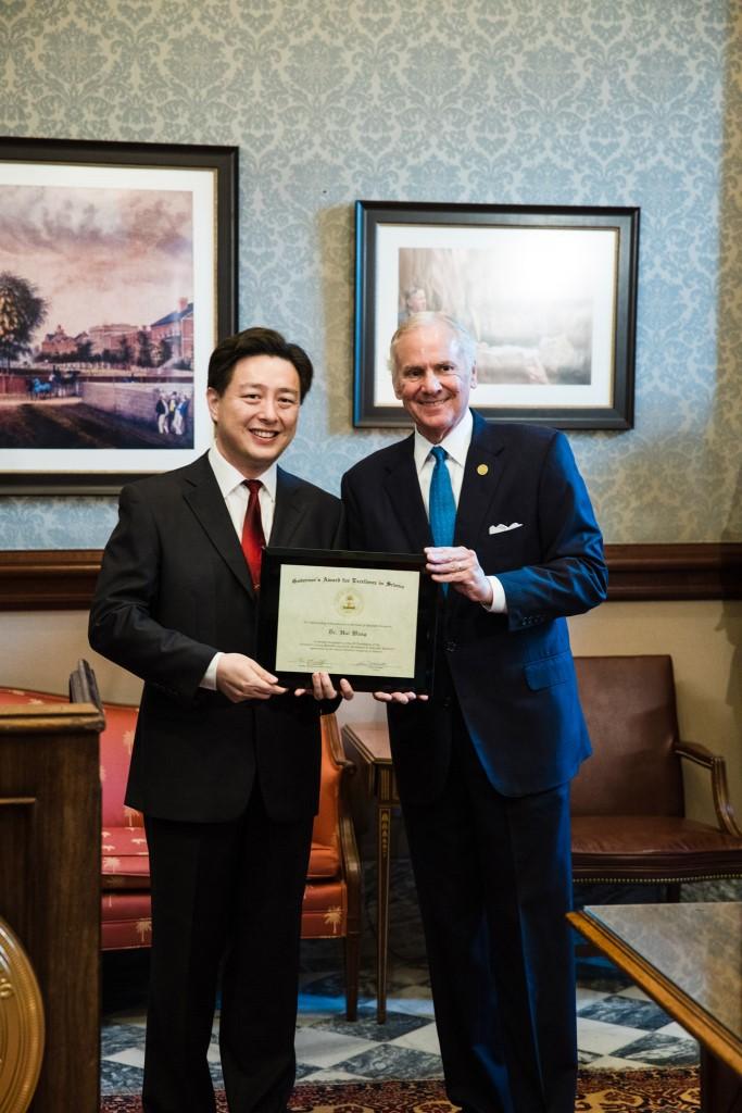 Governor Henry McMaster presents the 2019 Young Scientist Award for Excellence in Scientific Research to Dr. Hui Wang, an associate professor in the Department of Chemistry and Biochemistry, College of Arts and Sciences.