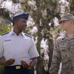 2 AFROTC Cadets in blue and camo talking