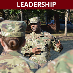 Man in camouflage uniform speaking to group. Headline: Leadership