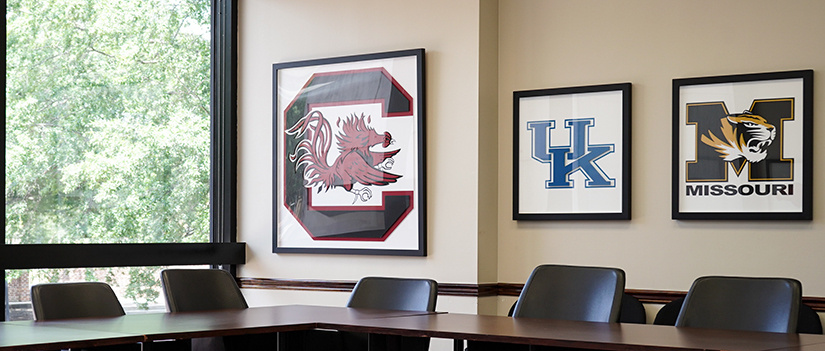 A framed Gamecock sign hangs in the SEC conference room in Russell House.