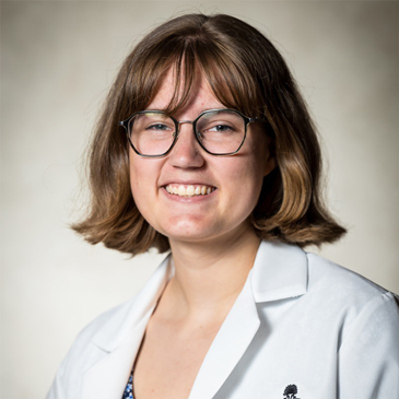 professional headshot of girl with glasses and a lab coat