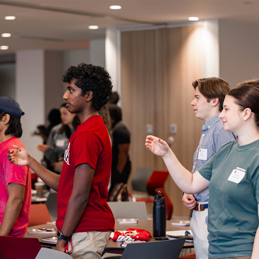 Students stand to sing the alma mater, "We Hail Thee, Carolina," during Imagine Carolina 2025