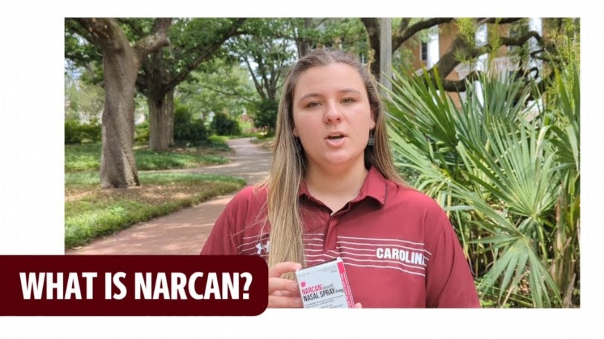 "What is Narcan?" student holding Narcan.