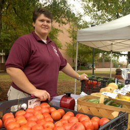 vendor with fruit at farmers market