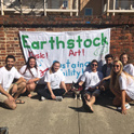 students posing with the earthstock banner on Greene Street