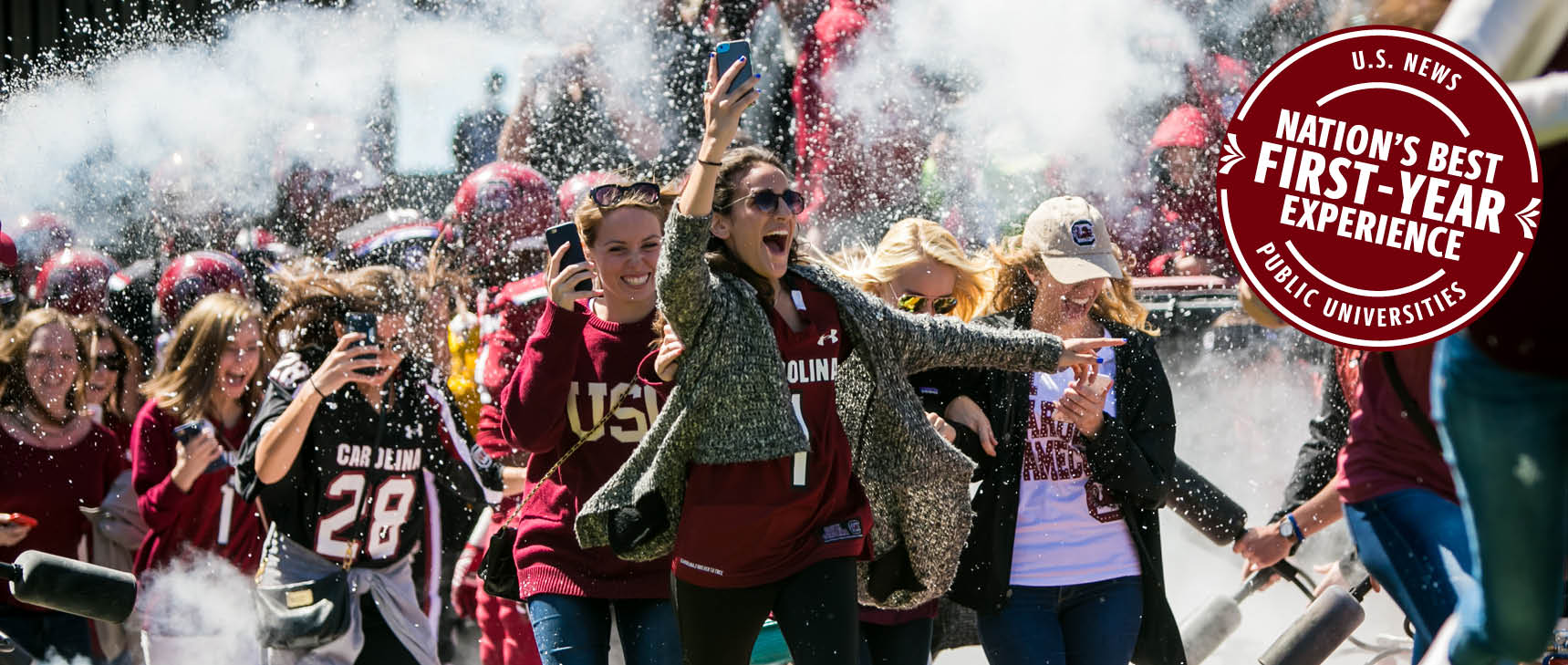 Students running out the tunnel at Williams-Brice stadium with overlaid stamp stating US News Public University Nation's Best First-Year Experience.