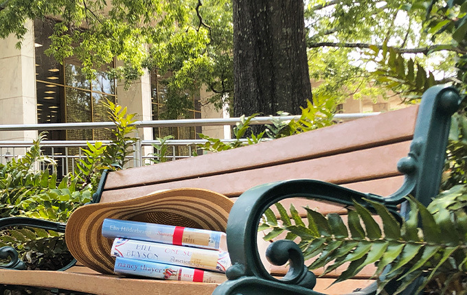 books on a bench outside of Thomas Cooper Library