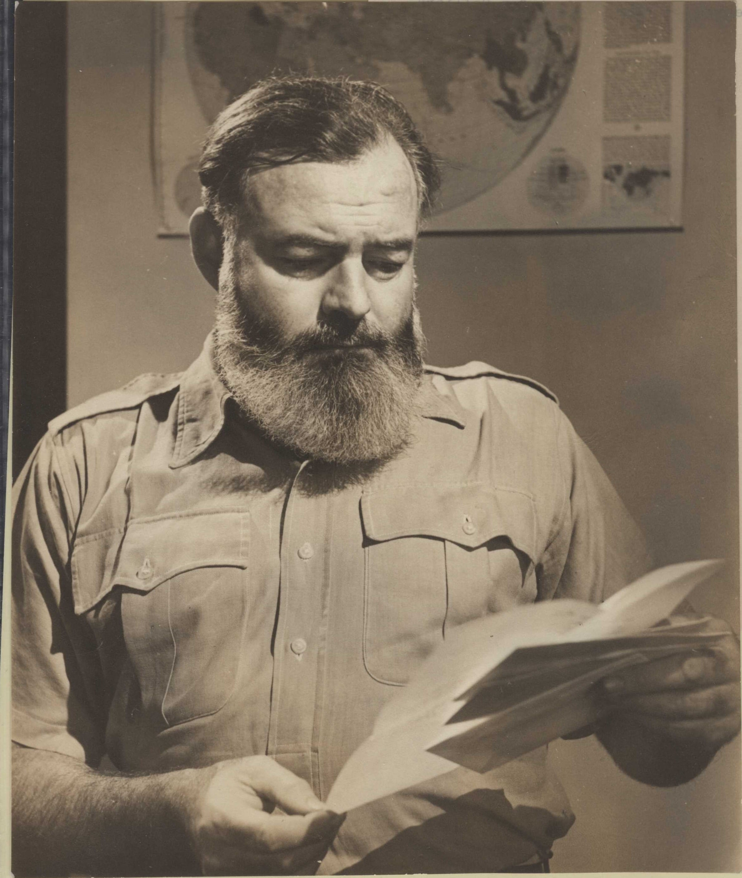 Hemingway reading a letter.