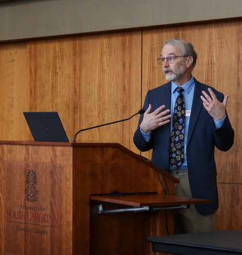 man speaking at podium