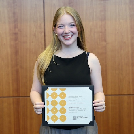 Maggie Davisson holding her award