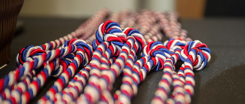 close up of red, white and blue graduation cords