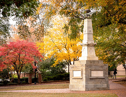 Maxcy Monument at the center of the horseshoe surrounded by beautiful red and yellow fall trees.