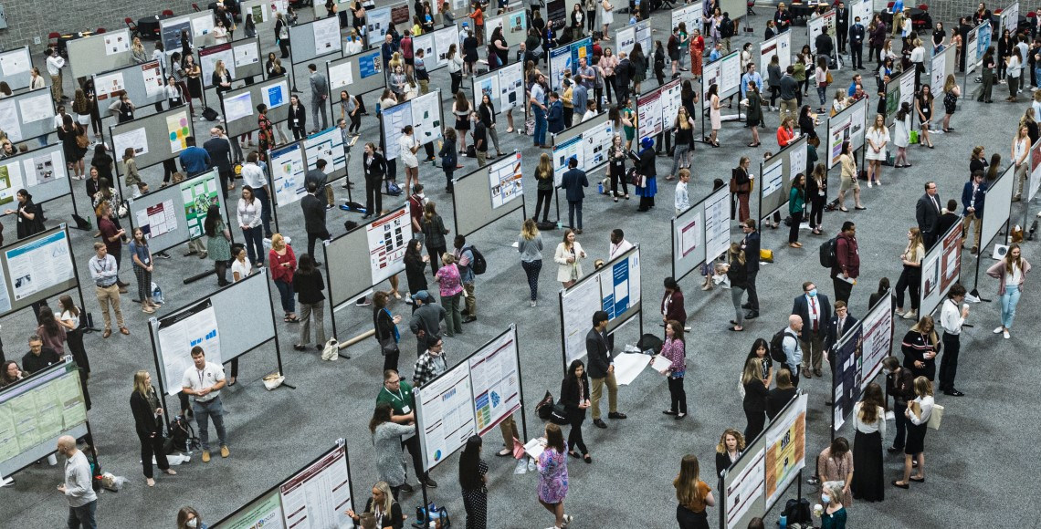 Banner Image - Overhead photo of rows of posters and presenters at a previous Discover USC event.