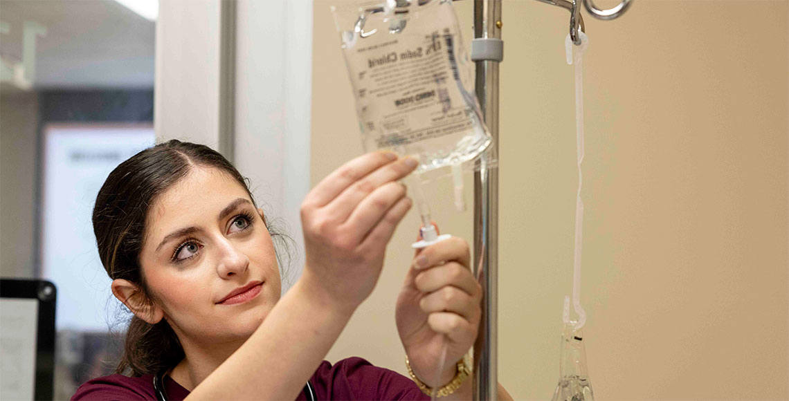 Nursing student demonstrating IV refill