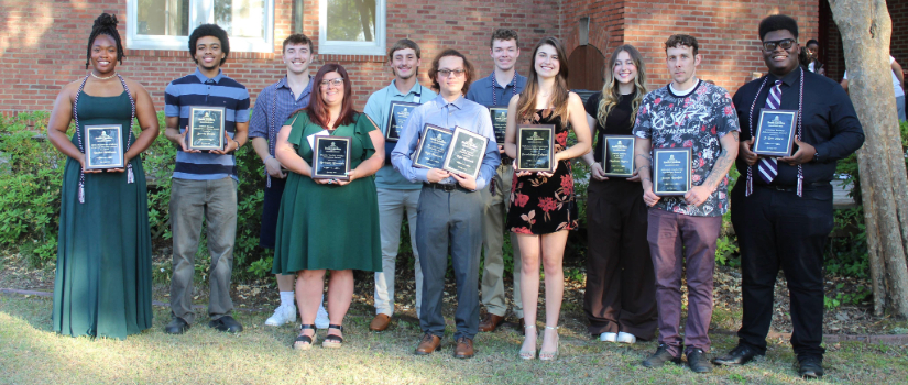 Academic Award winners hold their plaques.
