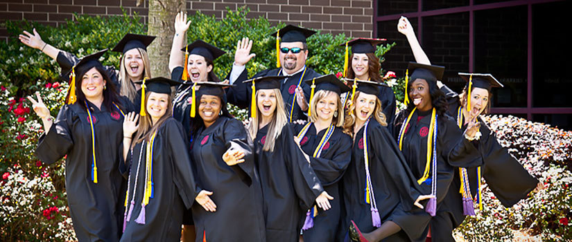 A group of graduates celebrate graduation.