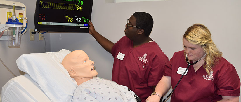 Nursing students work in the simulation lab.
