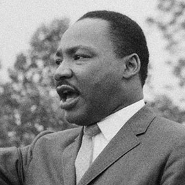 Martin Luther King Jr. faces left, delivering a speech