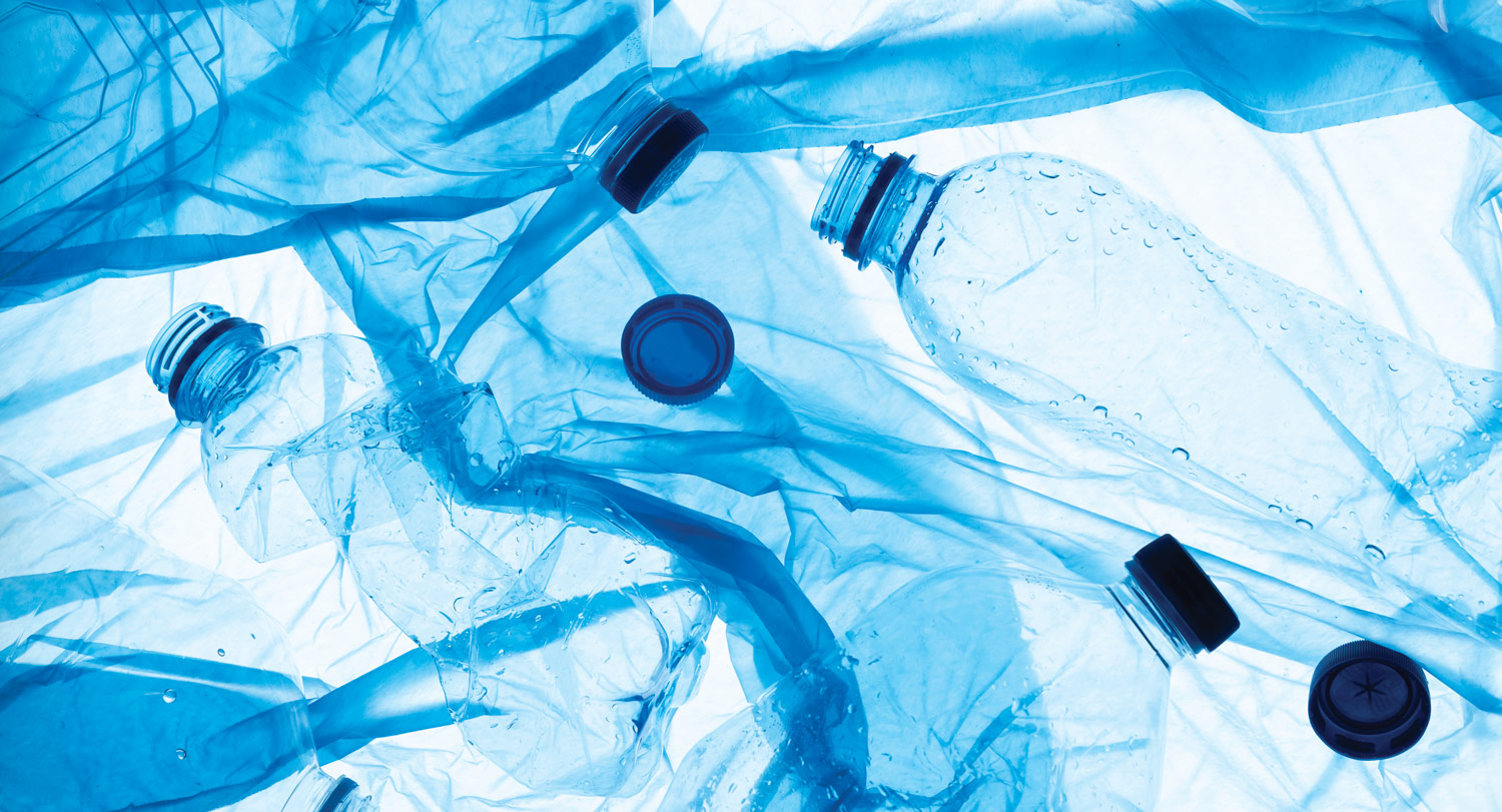 A background of empty plastic water bottles with a blue tint.