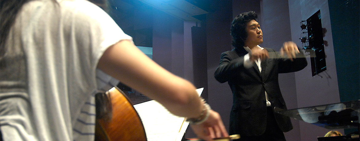 student conducting an orchestra