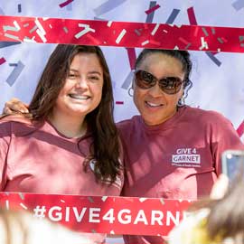Dawn Staley poses with a student during Give4Garnet