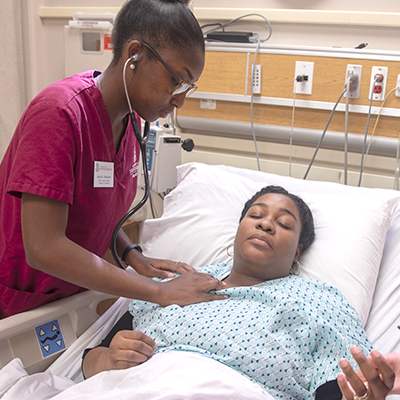 Nursing student taking a patient's vitals. 