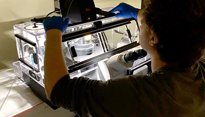 Researcher working with a piece of equipment in the lab.
