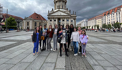 Students in a plaza in Germany studying abroad.