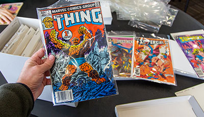 Hand holding a comic book called Thing.