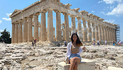 Student sitting in front of the Parthenon in Athens, Greece.