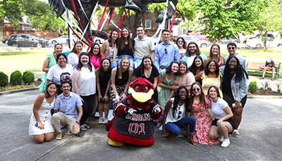 Group of students posed with the Cocky statue.