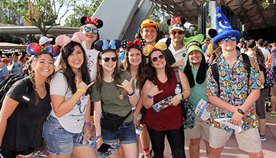 Group of students wearing Mickey ears and hats at Disney's Epcot.