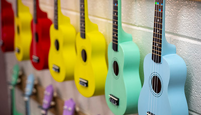 ukuleles hanging on wall of a music class room