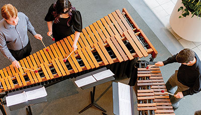 Percussion performers at a large xylophone taken from above. 