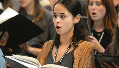 Student singing in a choir in class. 