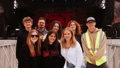 Group of students on stage at a fundraising event.