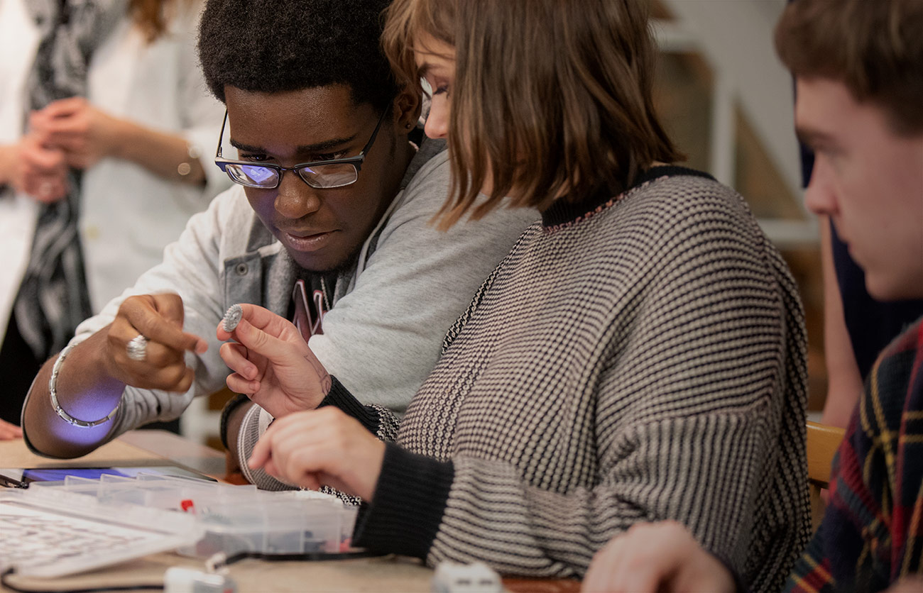 Two students working together on a lego project. 