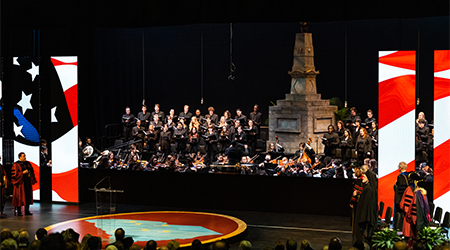 The stage at the Presidential Investiture featuring a replica of the Maxcy Monument and the SC state outline on the floor with an orchestra and choir on the stage. 